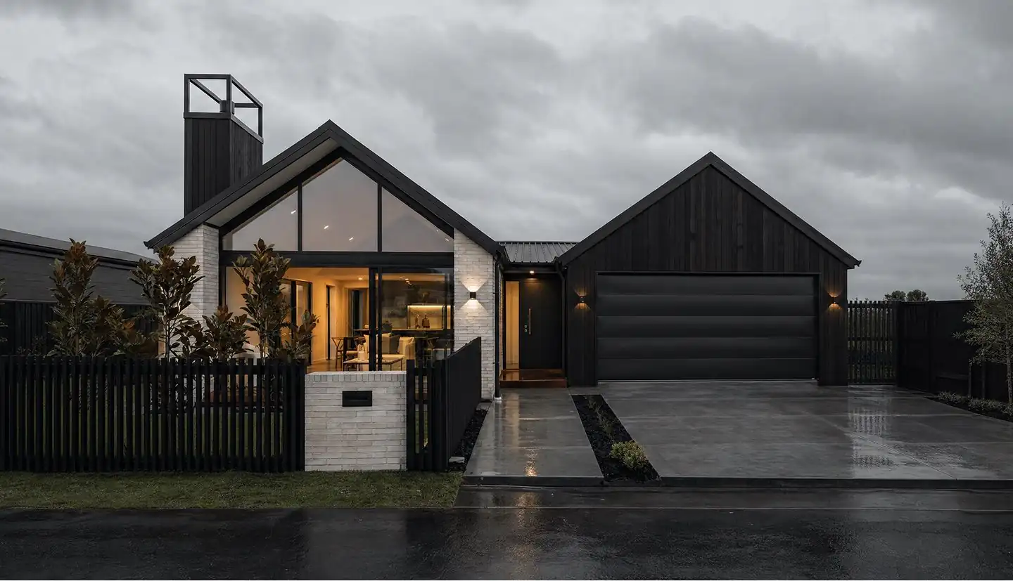Dark-stained modern Christchurch home at dusk, freshly painted exterior